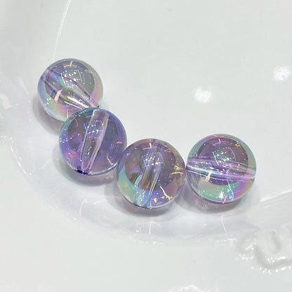 Four transparent purple acrylic round beads with iridescent reflections and visible through-holes.