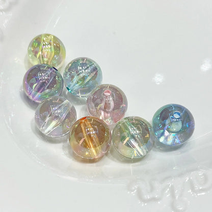 Eight transparent acrylic round beads in mixed colors with iridescent reflections and visible holes.