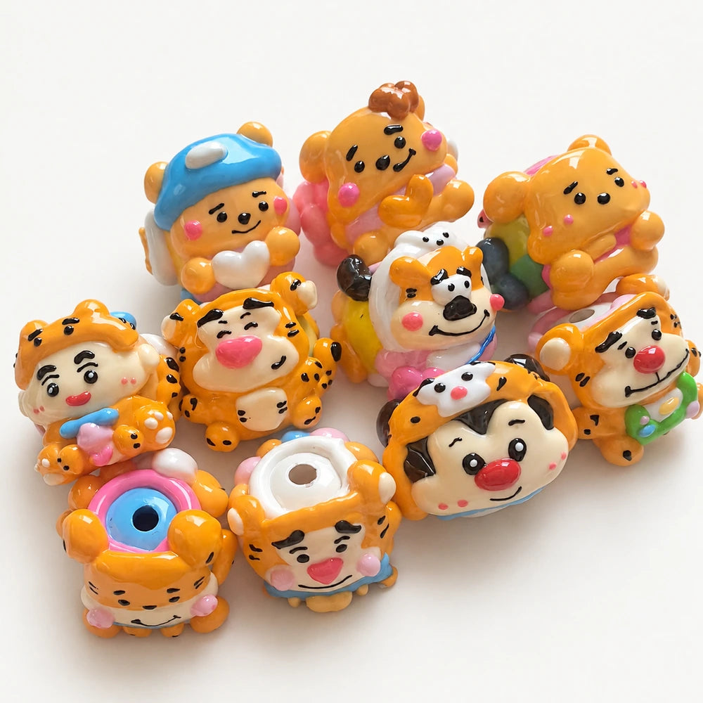 Set of 10 orange and yellow hand-painted acrylic beads with expressive faces and raised pink and blue details.