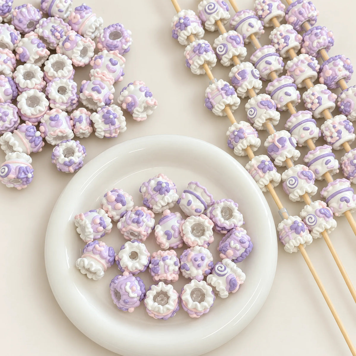 Lavender-inspired pastel purple and white 3D hand-painted beads displayed with craft rods and white bowl