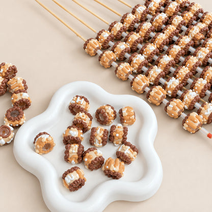 Light coffee brown hand-painted 3D beads in a white dish with caramel, cream and cocoa details