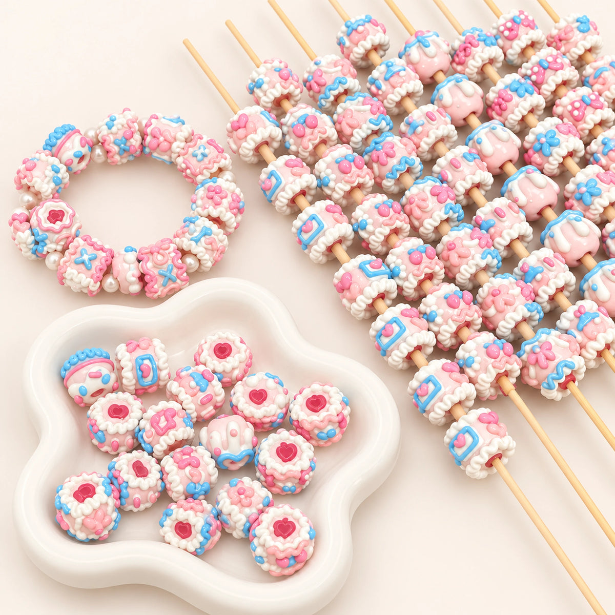 Pastel pink and blue envelope-inspired hand-painted 3D beads in a white petal bowl, with DIY beadable pen ideas